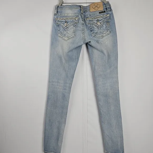 Miss Me factory distressed, rhinestone and embroidered skinny jeans size 27